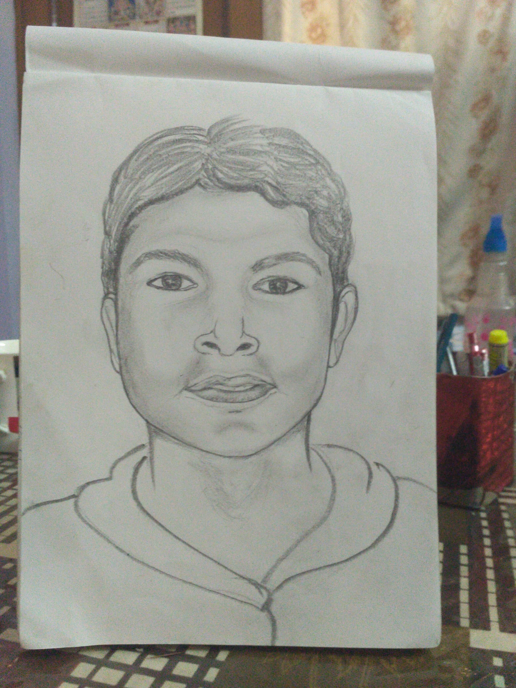 Graphite portrait of a young man, frontal gaze