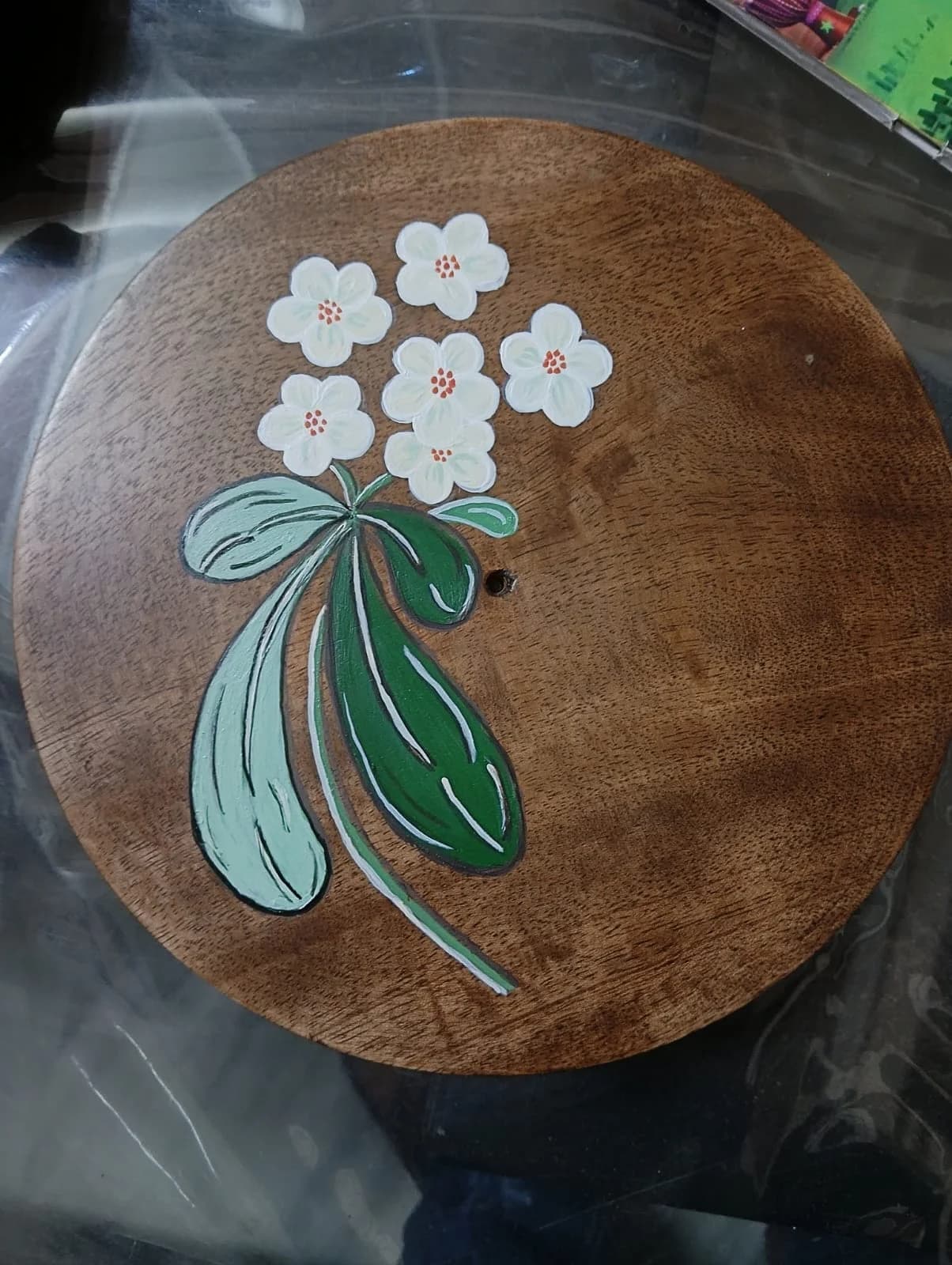 Jasmine blossoms hand-painted on a round wooden plate