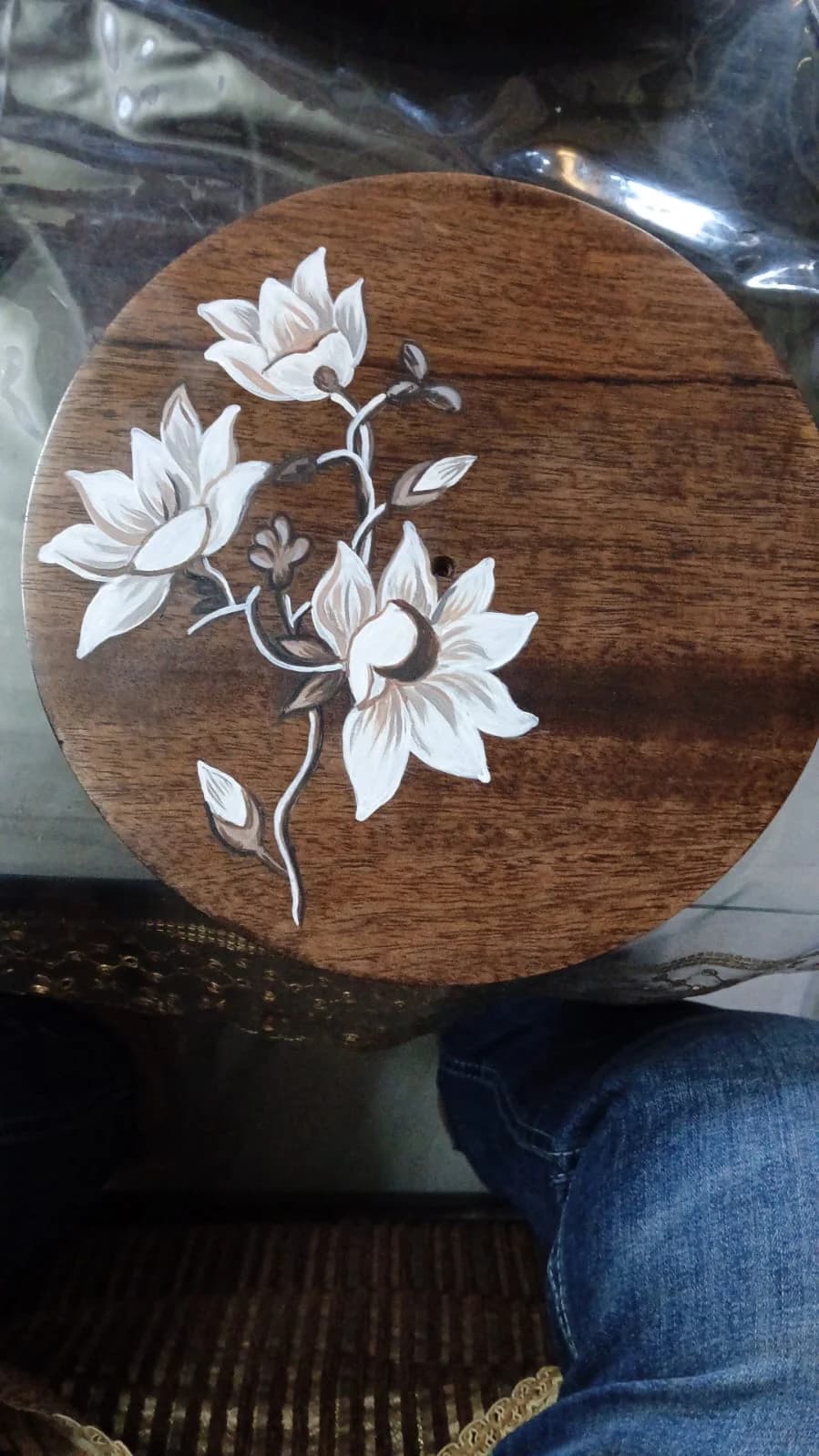 Magnolia blooms hand-painted on a round wooden plate