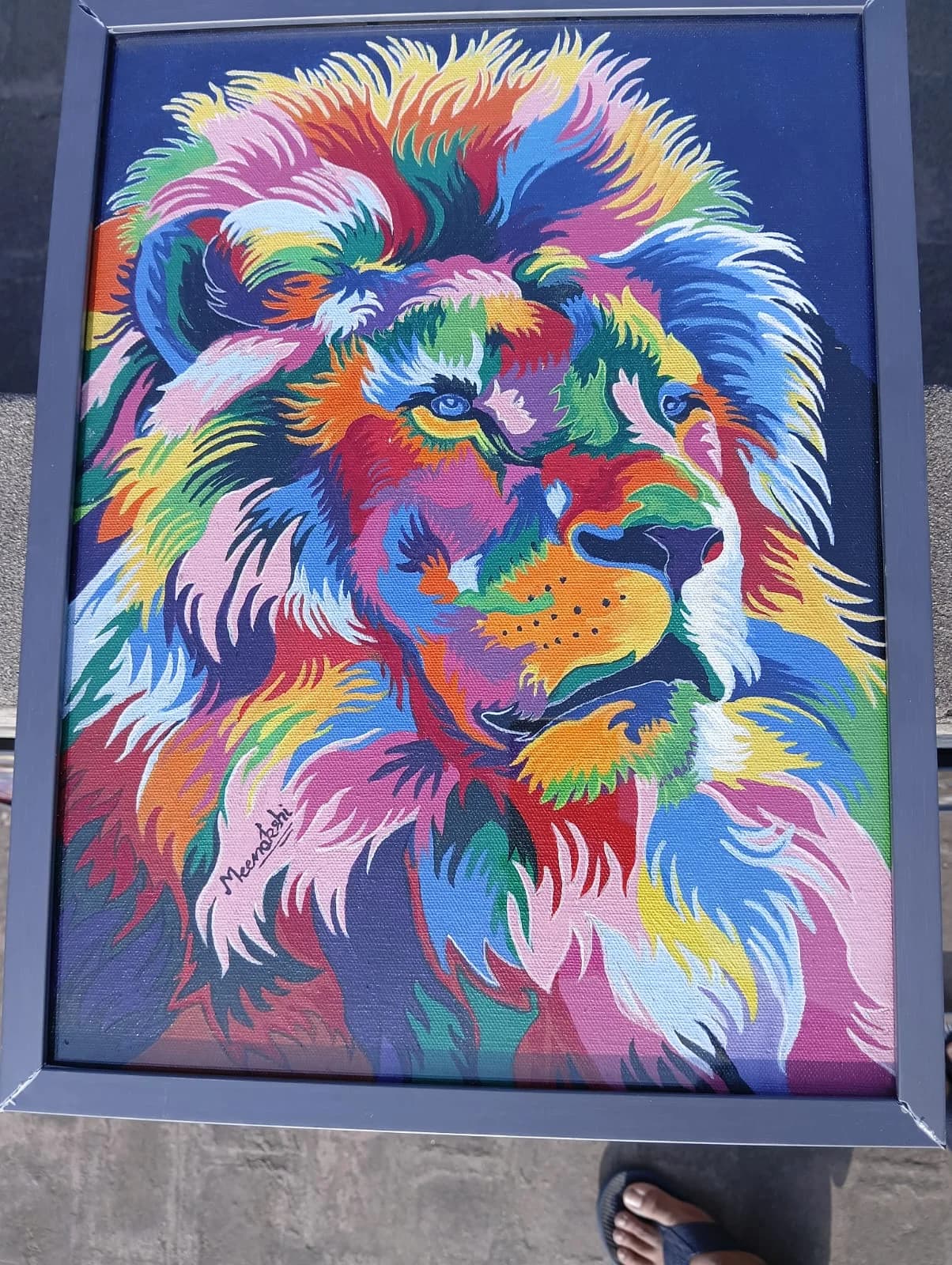 Vibrant multicolour lion head painting on a navy blue background