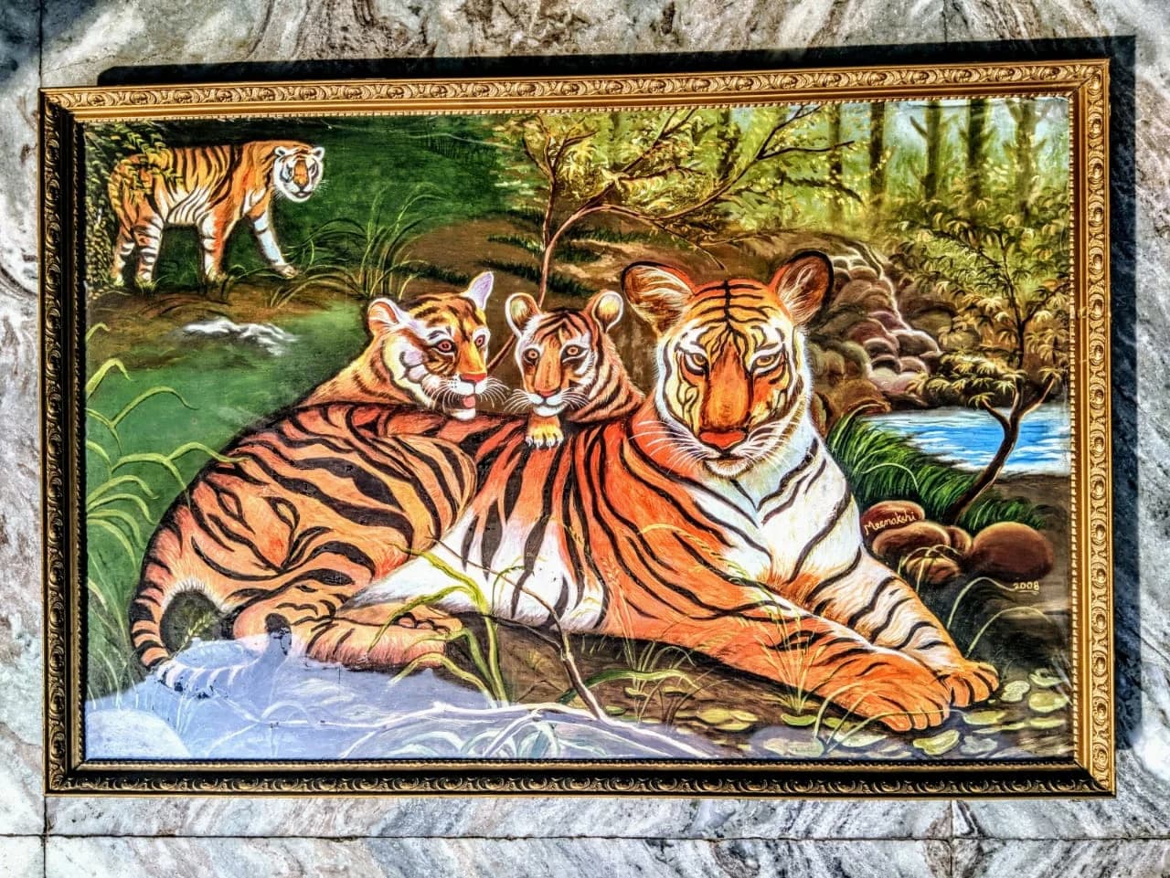 Tiger family, mother and cubs resting in a green forest