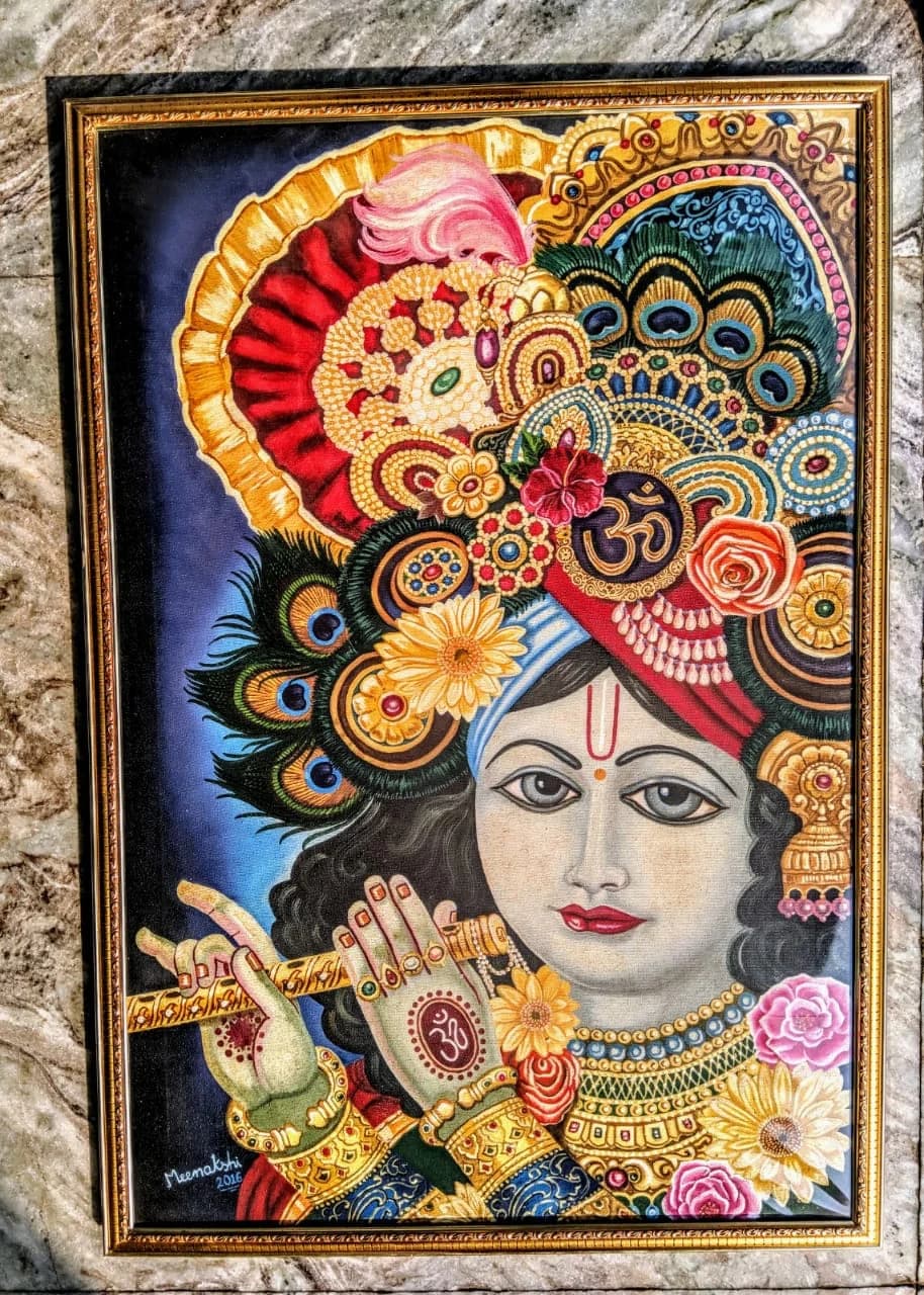 Krishna in an ornate gold crown against a dark blue ground
